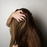 photo of woman covering face with her hair